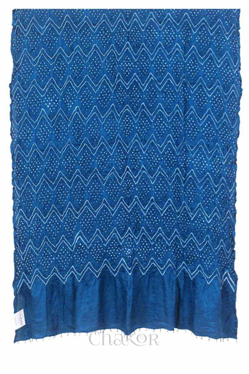 full view of a blue rai bandhej dupatta in gaji silk ,pallu edge detailed with beads.Text reads Chakor brand watermark.