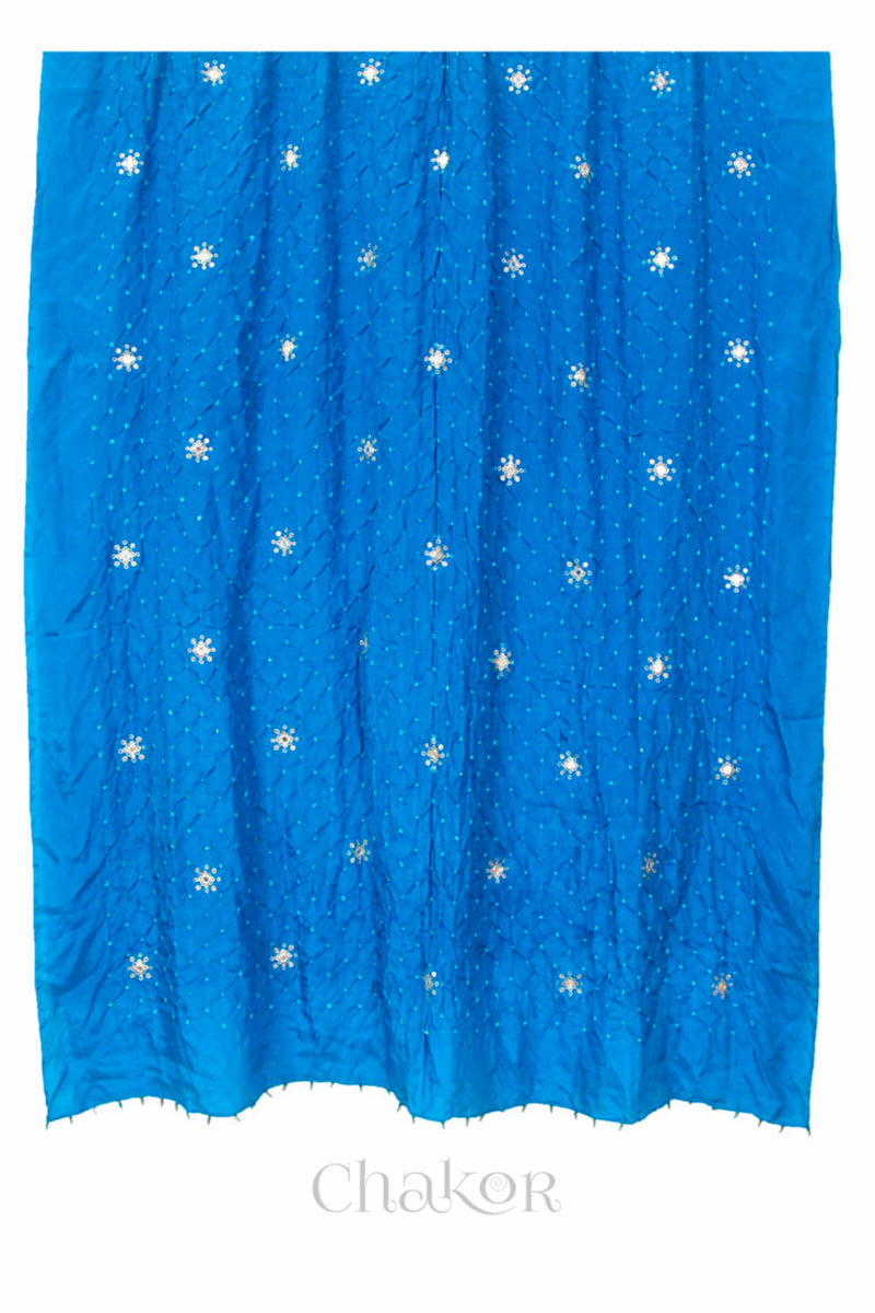 Full view of peacock blue Bandhani mulberry silk dupatta with tie-dye dot pattern & detailed with Mirror work, Sequin work, Zari work, Bead edging.