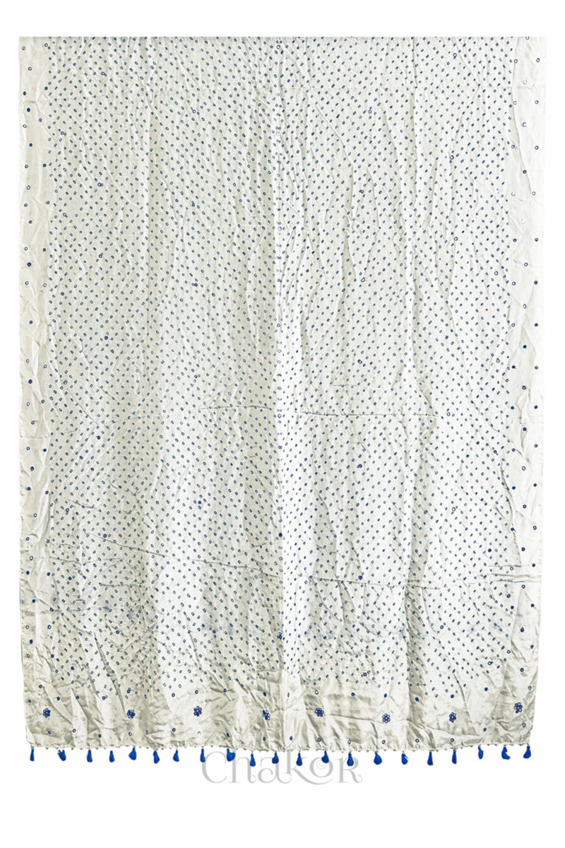 Full view of off white Bandhani mulberry silk dupatta with tie-dye dot pattern & detailed with Mirror work & tassels.