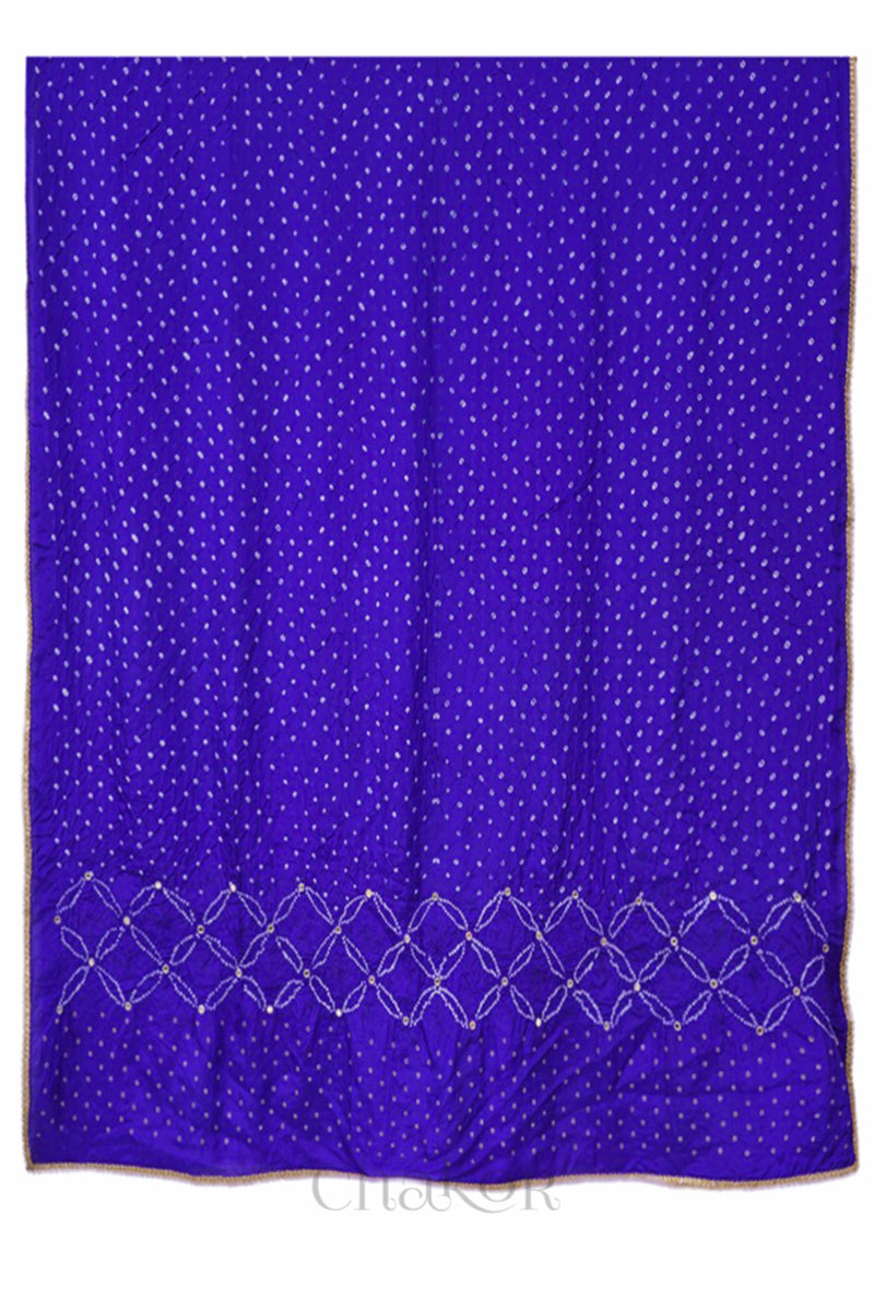 Full view of a purple Bandhani mulberry silk dupatta with tie-dye dot pattern & detailed with mirror work & golden lace on edge