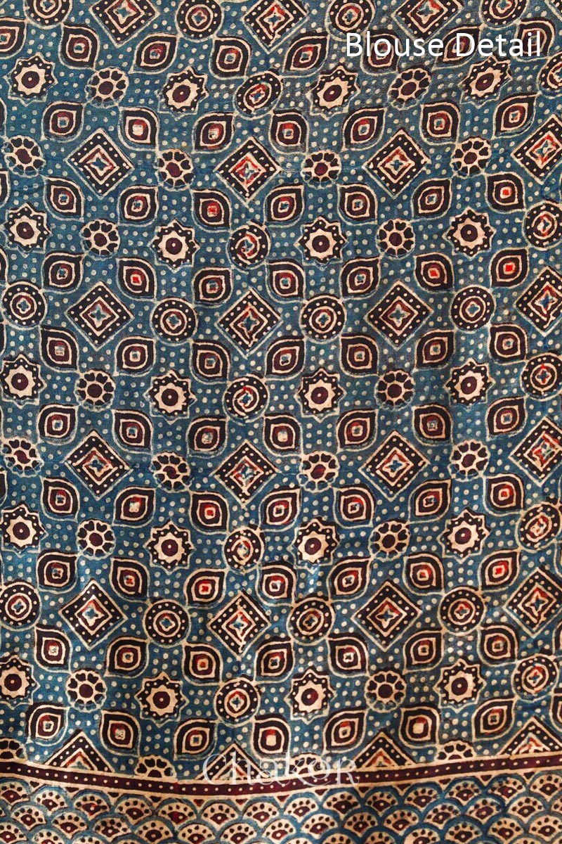 Blouse material of Coral Pink Bandhani Saree with Black Ajrakh printed border and pallu in pure gaji silk with traditional bandhej tie-dye, handcrafted in Kutch.