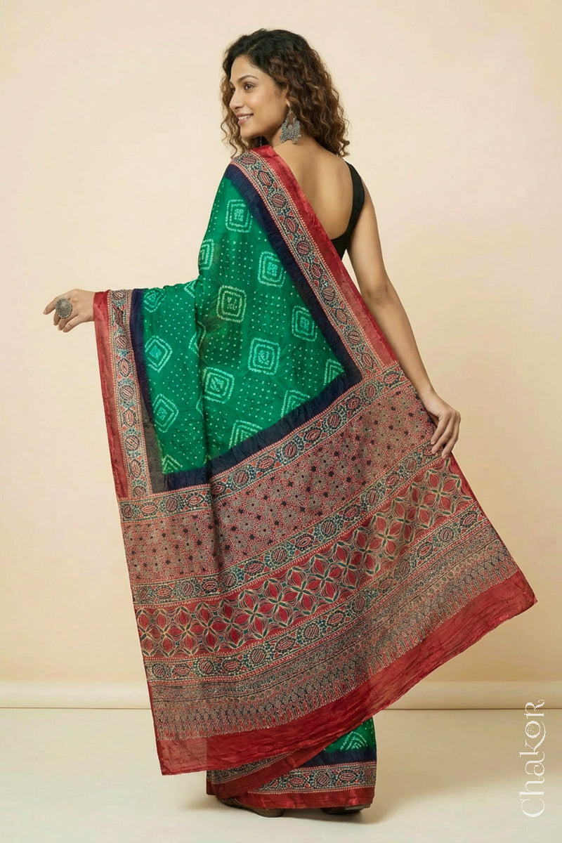 Woman wearing Green Bandhani Saree with Ajrakh printed border and pallu in pure gaji silk with traditional bandhej tie-dye, handcrafted in Kutch.