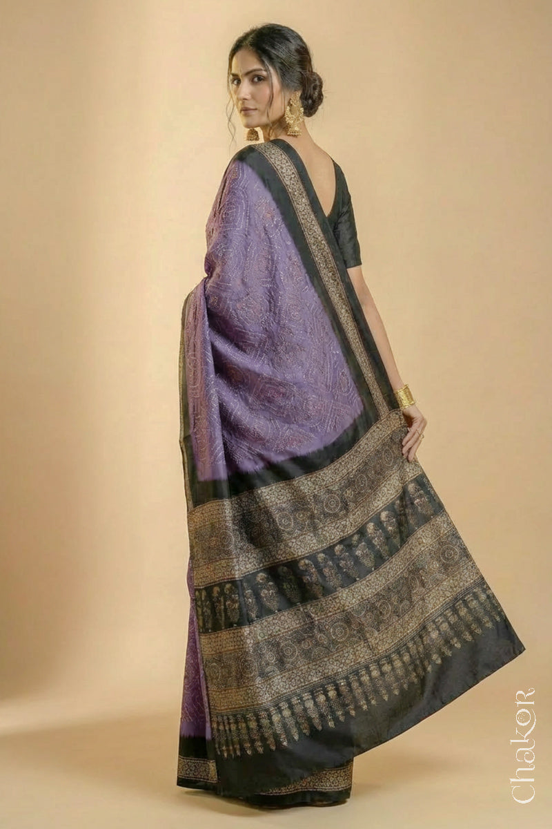 Woman wearing Mauve Bandhani Saree with Natural Black Ajrakh printed border and pallu in pure gaji silk with traditional bandhej tie-dye, handcrafted in Kutch.
