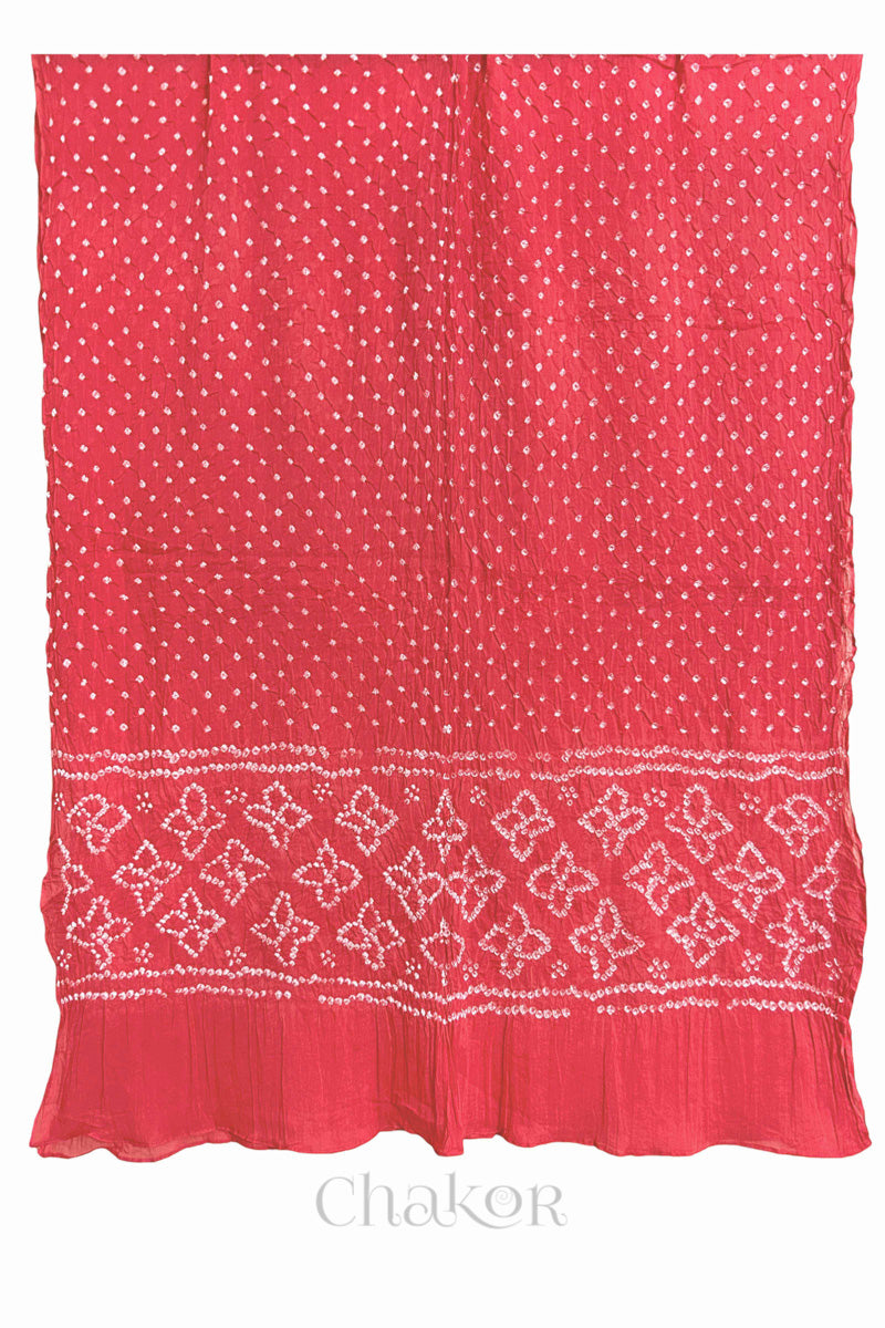 Full view of Coral pink Bandhani mulmul cotton dupatta with floral pallu and dotted body pattern.