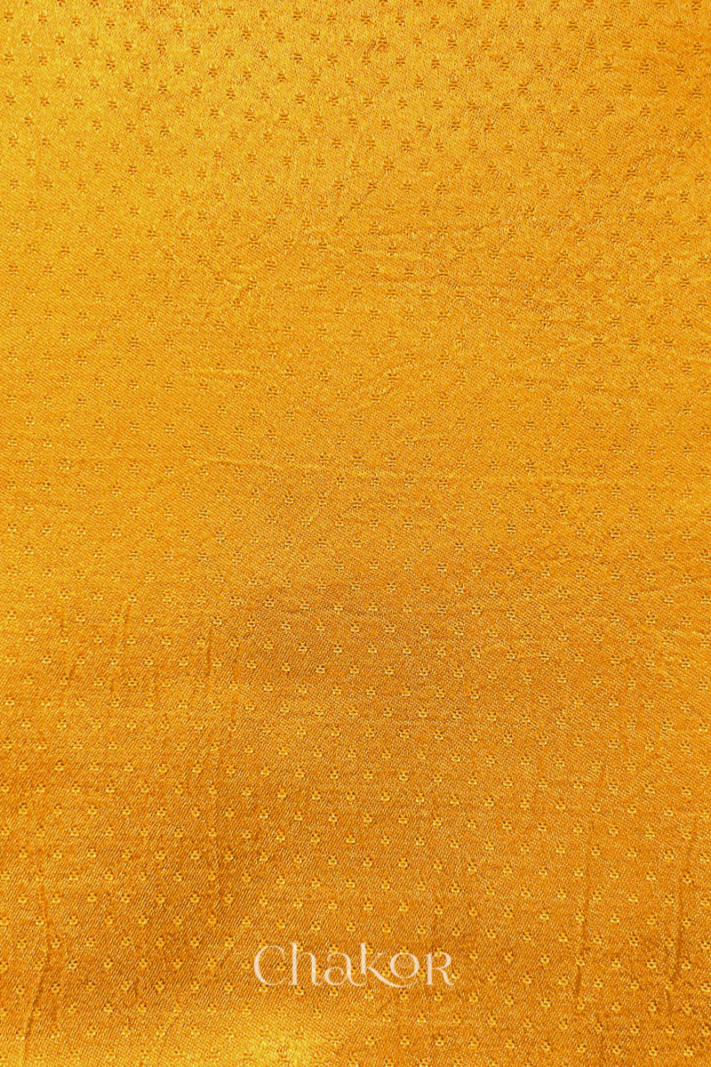 Golden yellow Mashru blouse fabric flat view with smooth surface.