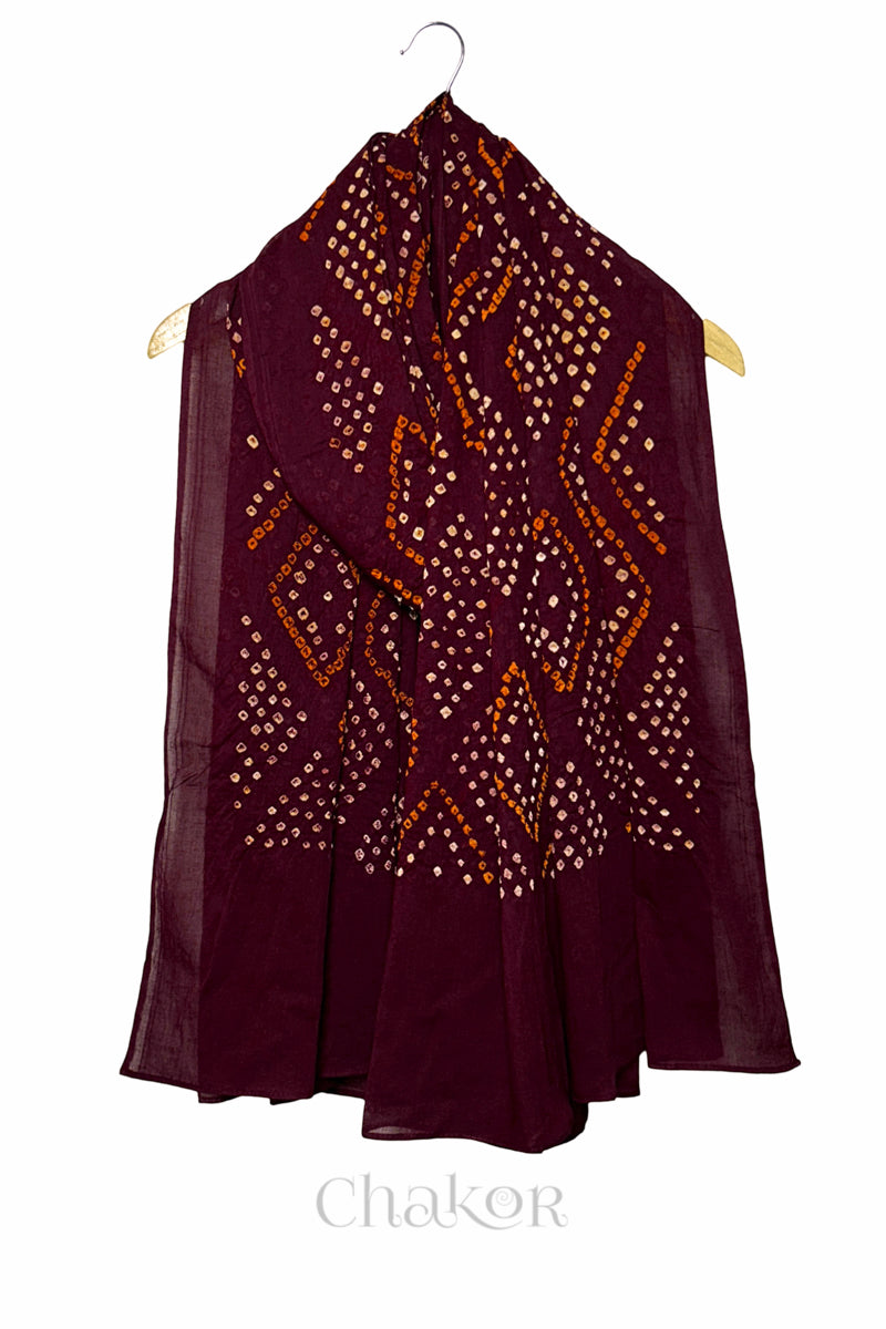 Full length view of handmade Kutch Bandhani dupatta in maroon mulmul cotton.