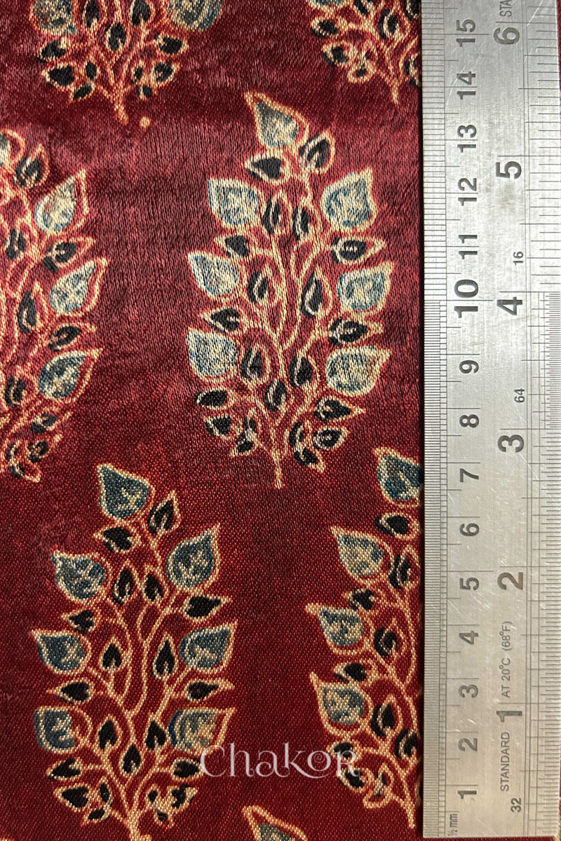 Close up of madder red ajrakh block printed mashru silk kurta fabric.