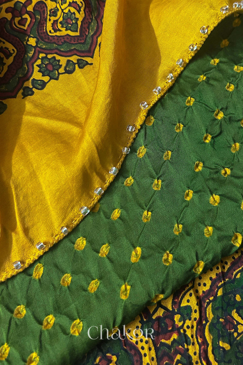 Green Bandhani and Mustard Ajrakh combination modal stole with glass bead edging detail on pallu end.