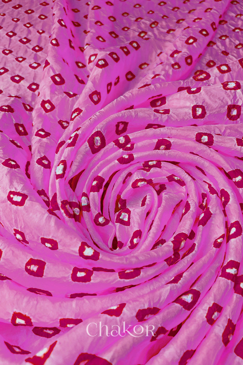 Light Pink Mulberry silk fabric with dual colour Pink bandhani dots, arranged in a swirling design & Chakor brand watermark.