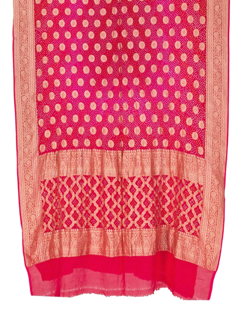 Pink dupatta with white bandhani dots and golden patterns.