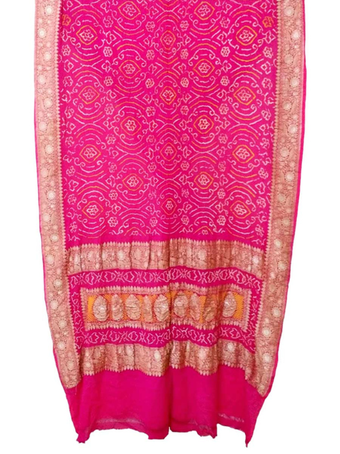 Pink Bandhani saree with gold border by CHAKOR.