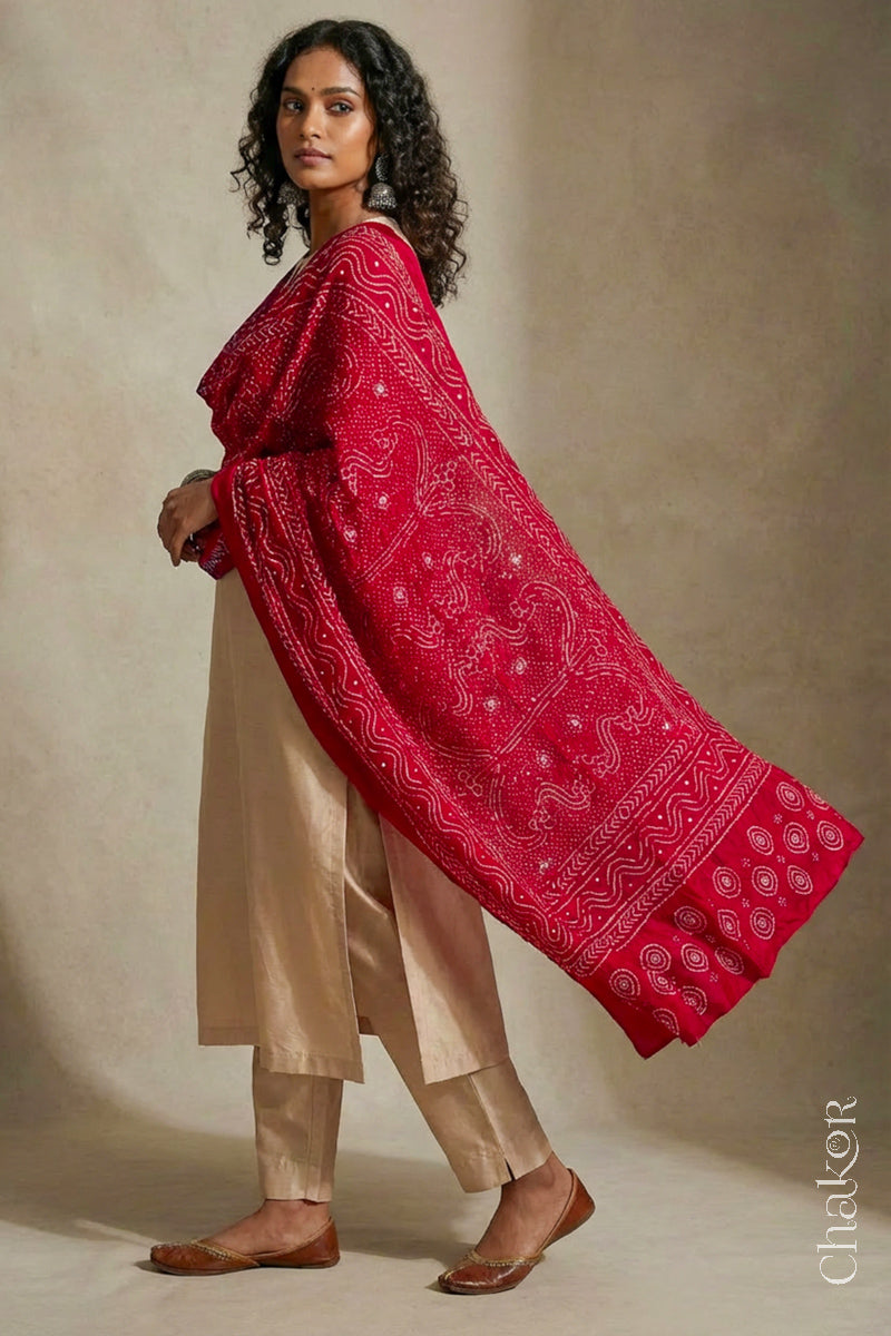 Model wearing red Bandhani mulberry silk dupatta with tie-dye dot pattern draped over a beige kurta.