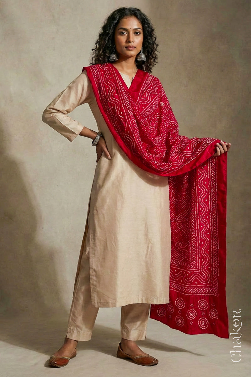 Model wearing red Bandhani mulberry silk dupatta with tie-dye dot pattern draped over a beige kurta.