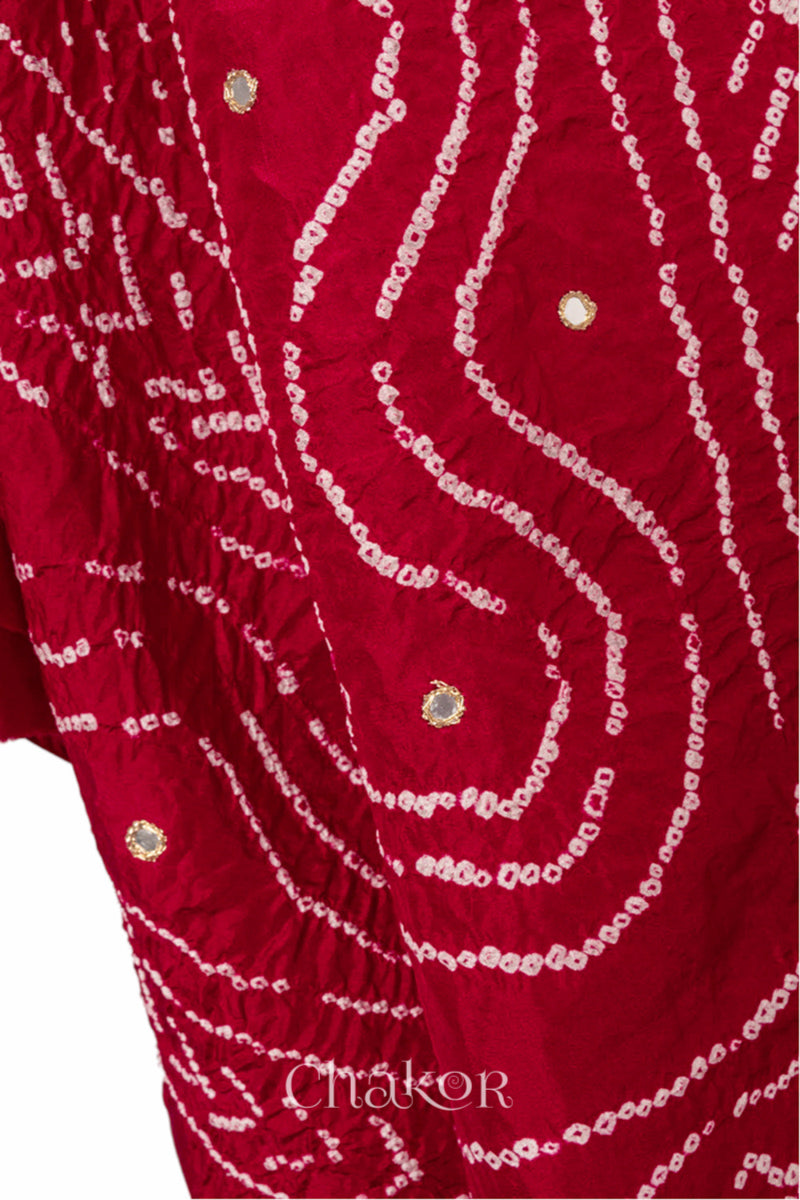close-up of red Bandhani mulberry silk dupatta with tie-dye dot pattern with mirror work.