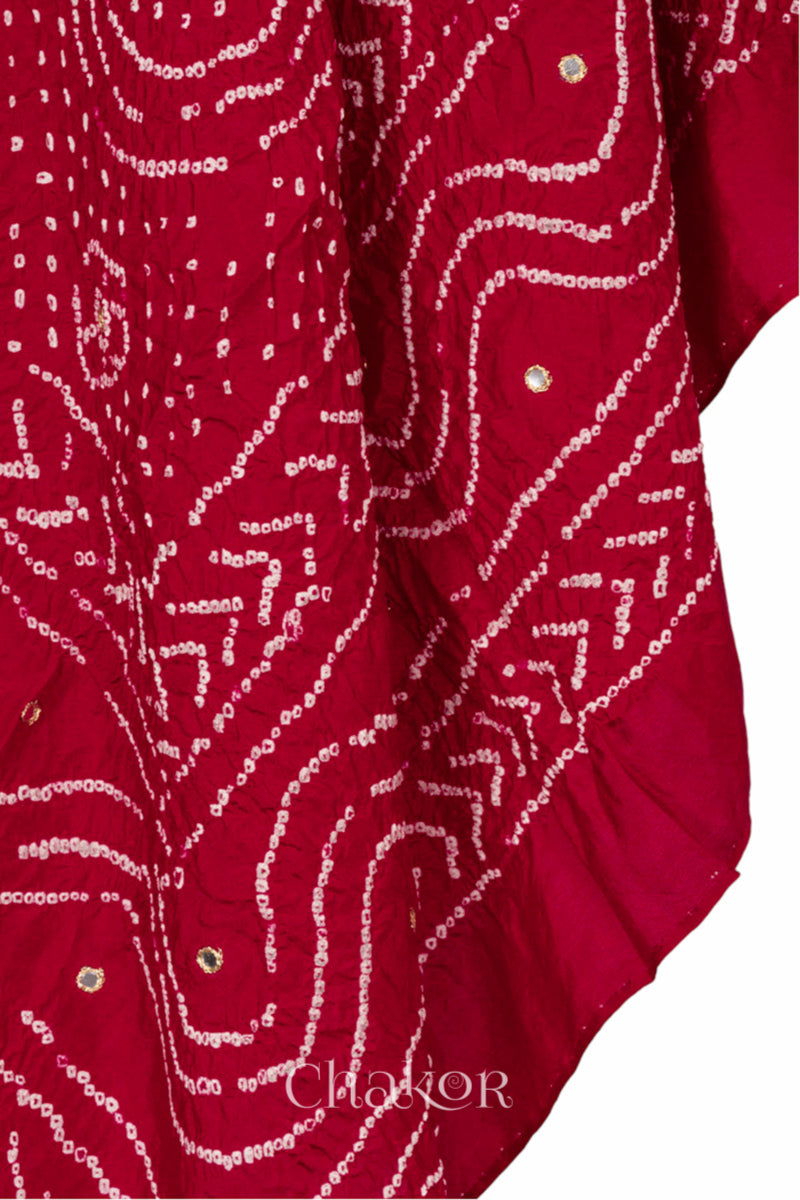 close-up of red Bandhani mulberry silk dupatta with tie-dye dot pattern with mirror work.