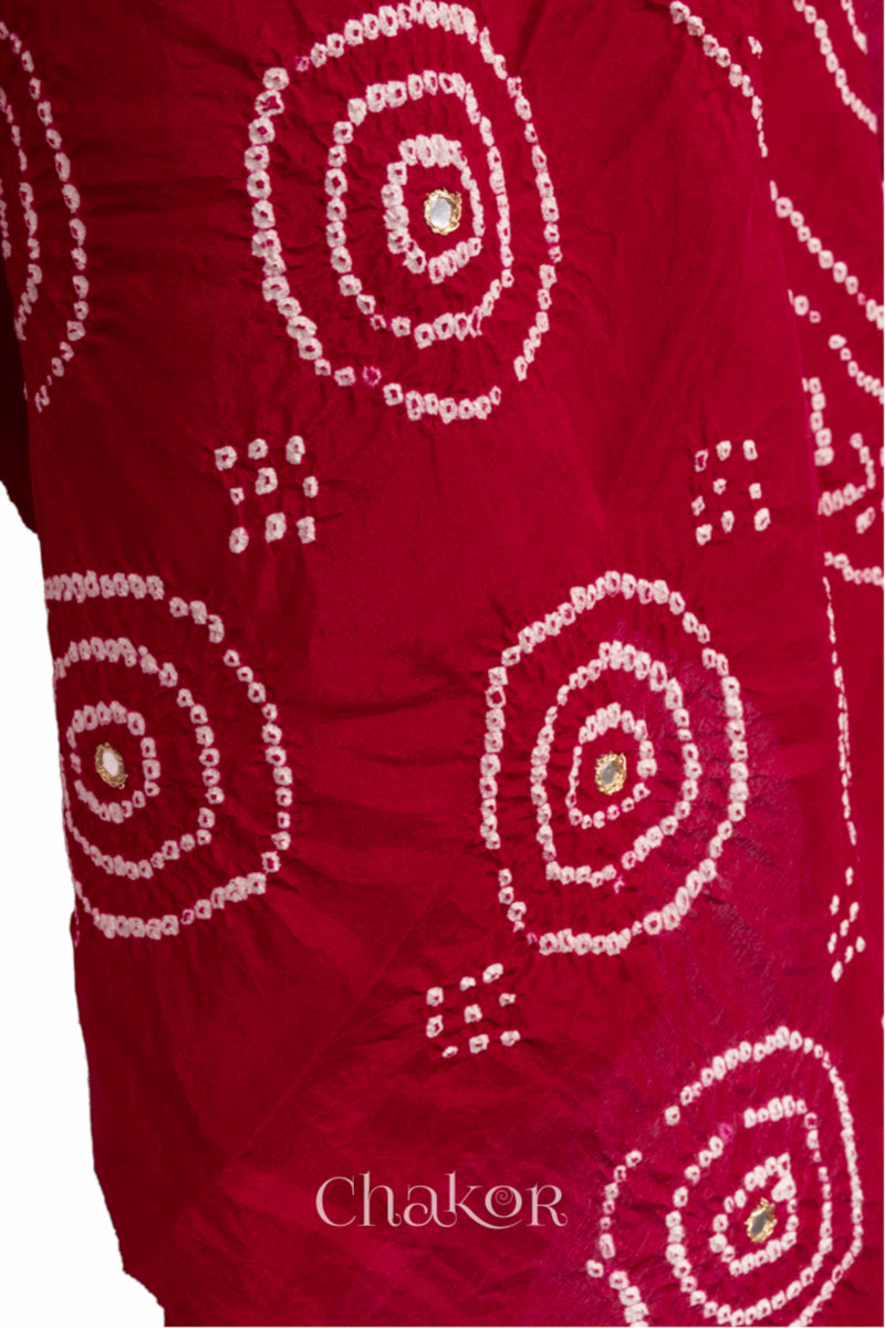 close-up of red Bandhani mulberry silk dupatta with tie-dye dot pattern with mirror work.