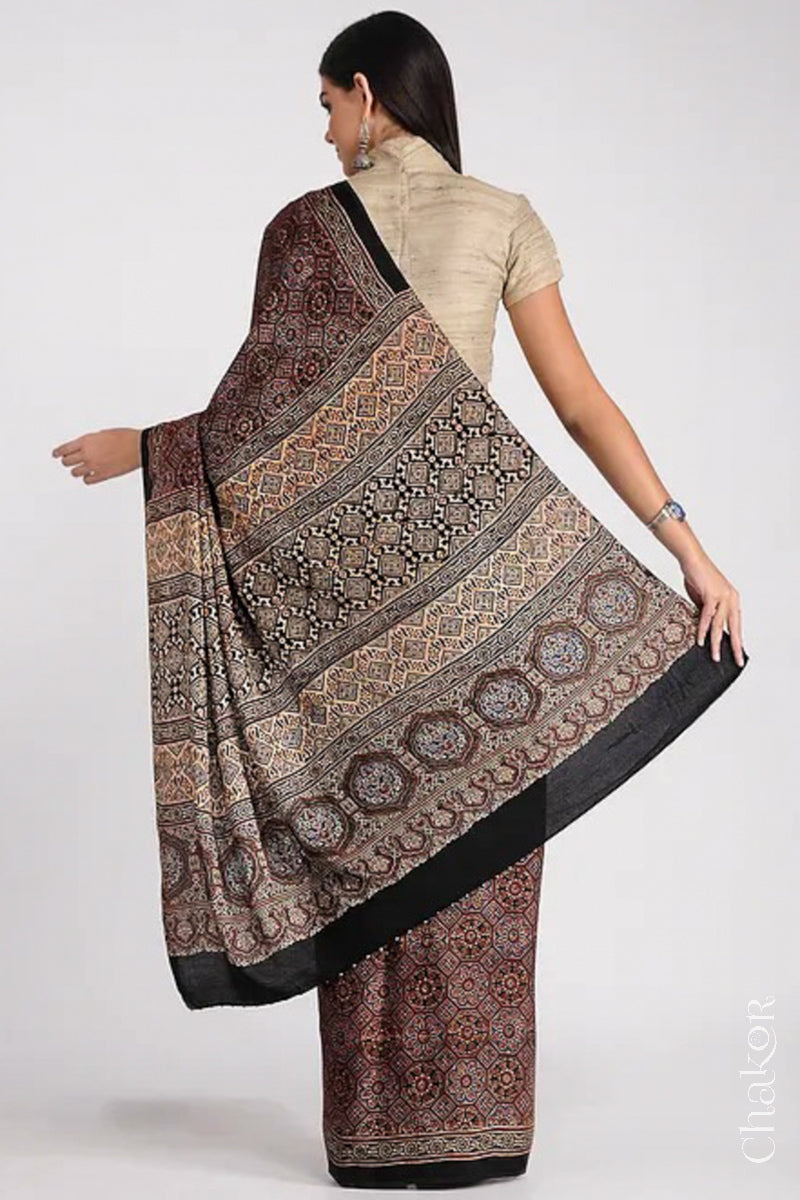 Woman Wearing Natural Dyed Black Ajrakh Printed Modal Cotton Saree Handcrafted in Kutch.