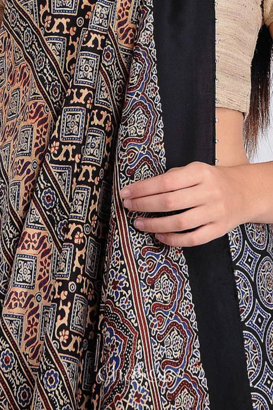 Woman wearing Natural Dyed Black Ajrakh Printed Modal Cotton Saree Handcrafted in Kutch.