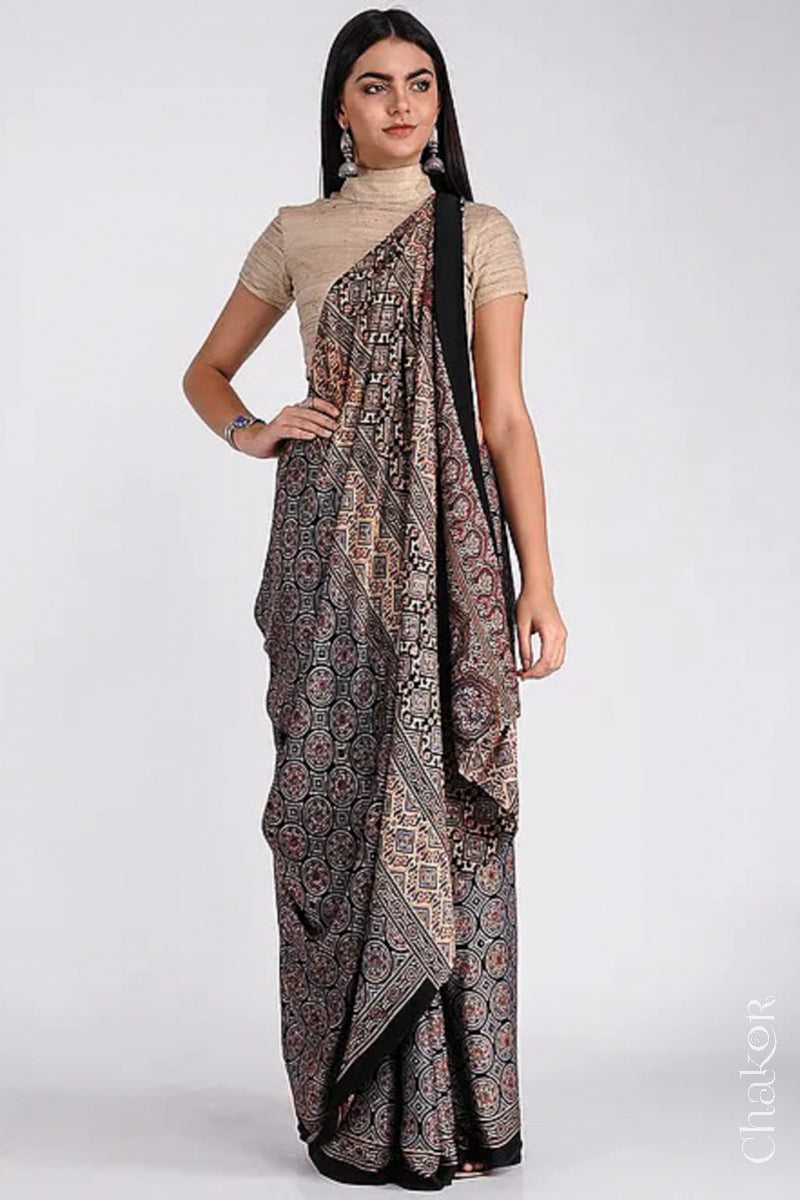 Woman wearing Natural Dyed Black Ajrakh Printed Modal Cotton Saree Handcrafted in Kutch.