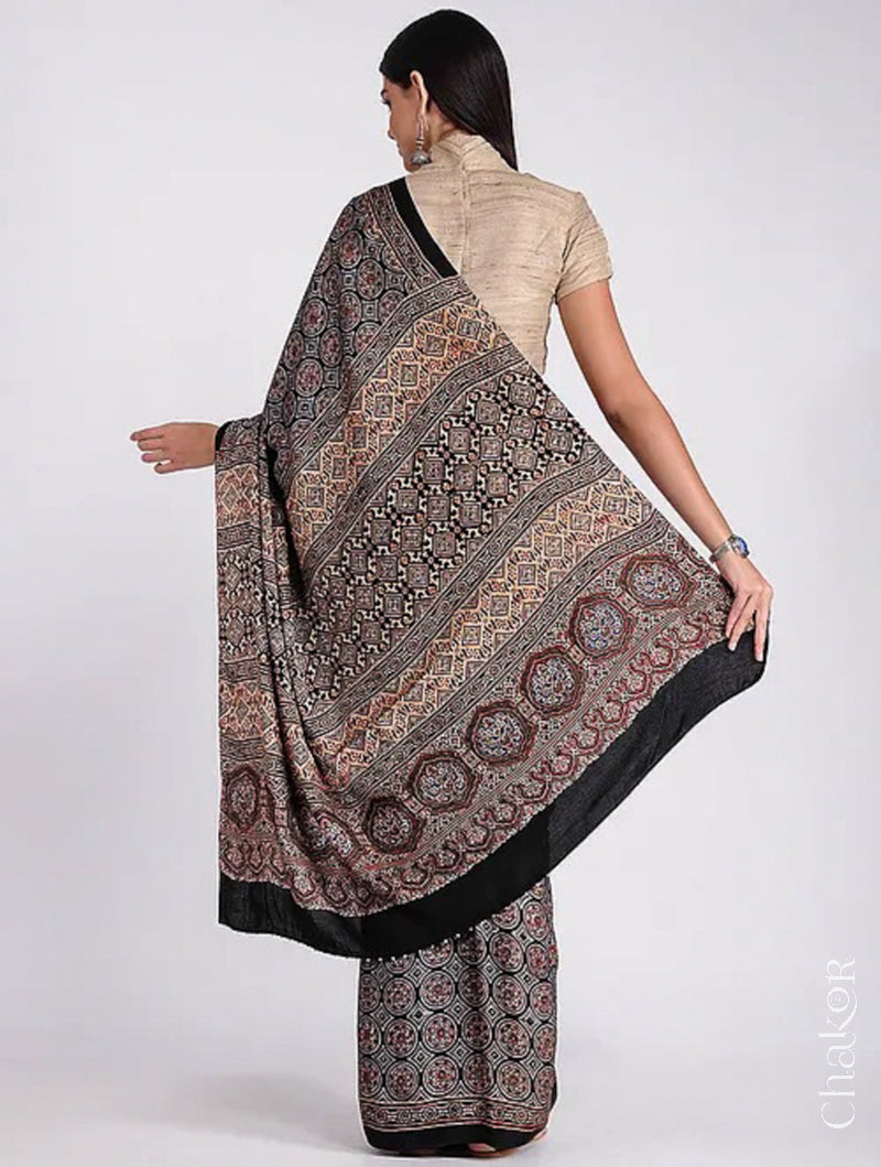 Woman wearing Natural Dyed Black Ajrakh Printed Modal Cotton Saree Handcrafted in Kutch.