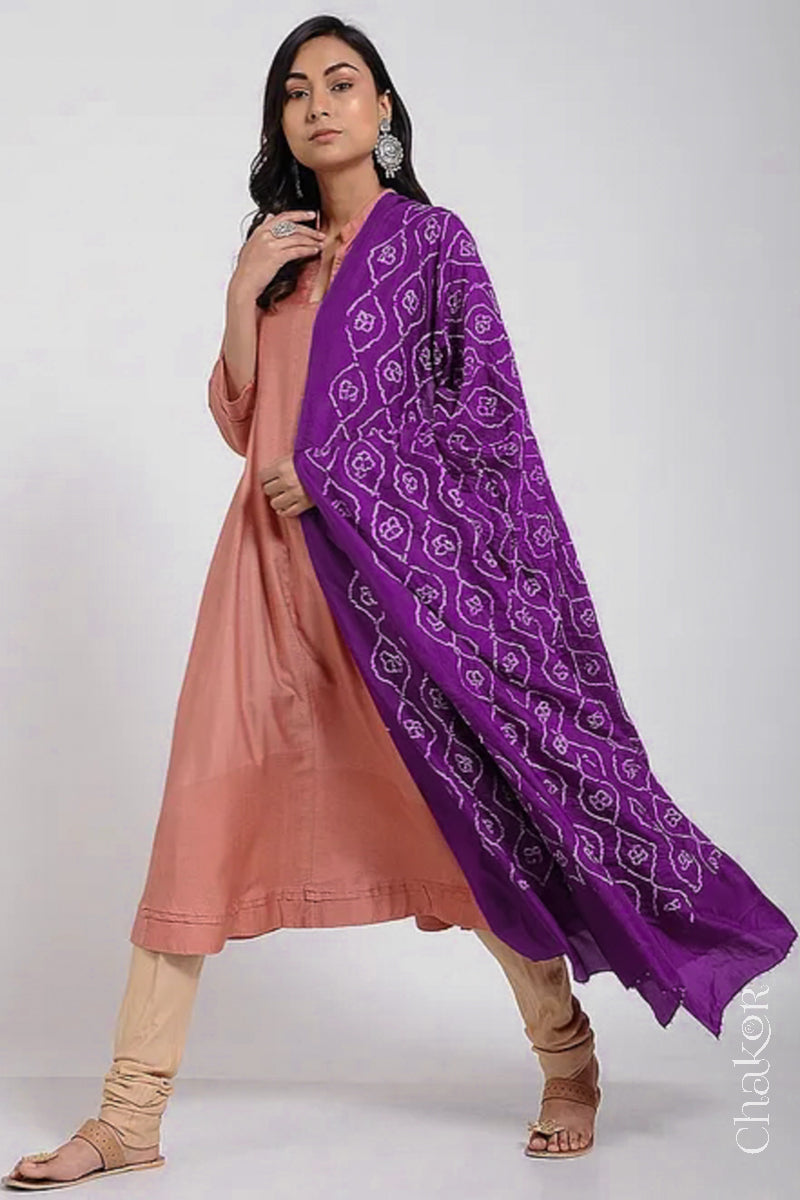 Model wearing wine Bandhani mulberry silk dupatta with tie-dye dot pattern draped over a beige kurta.