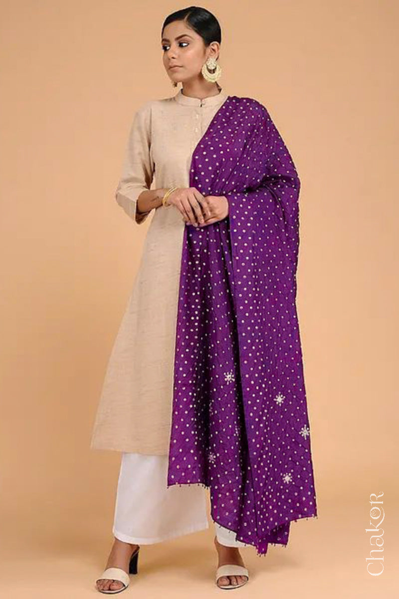 Close up of model wearing Wine Bandhani Mulberry Silk Dupatta featuring sequin and zari embroidery with beads pallu edgeover a beige kurta.