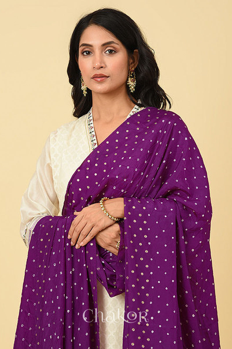 Close up of model wearing Wine Bandhani Mulberry Silk Dupatta embroidered with sequins over an offwhite kurta.
