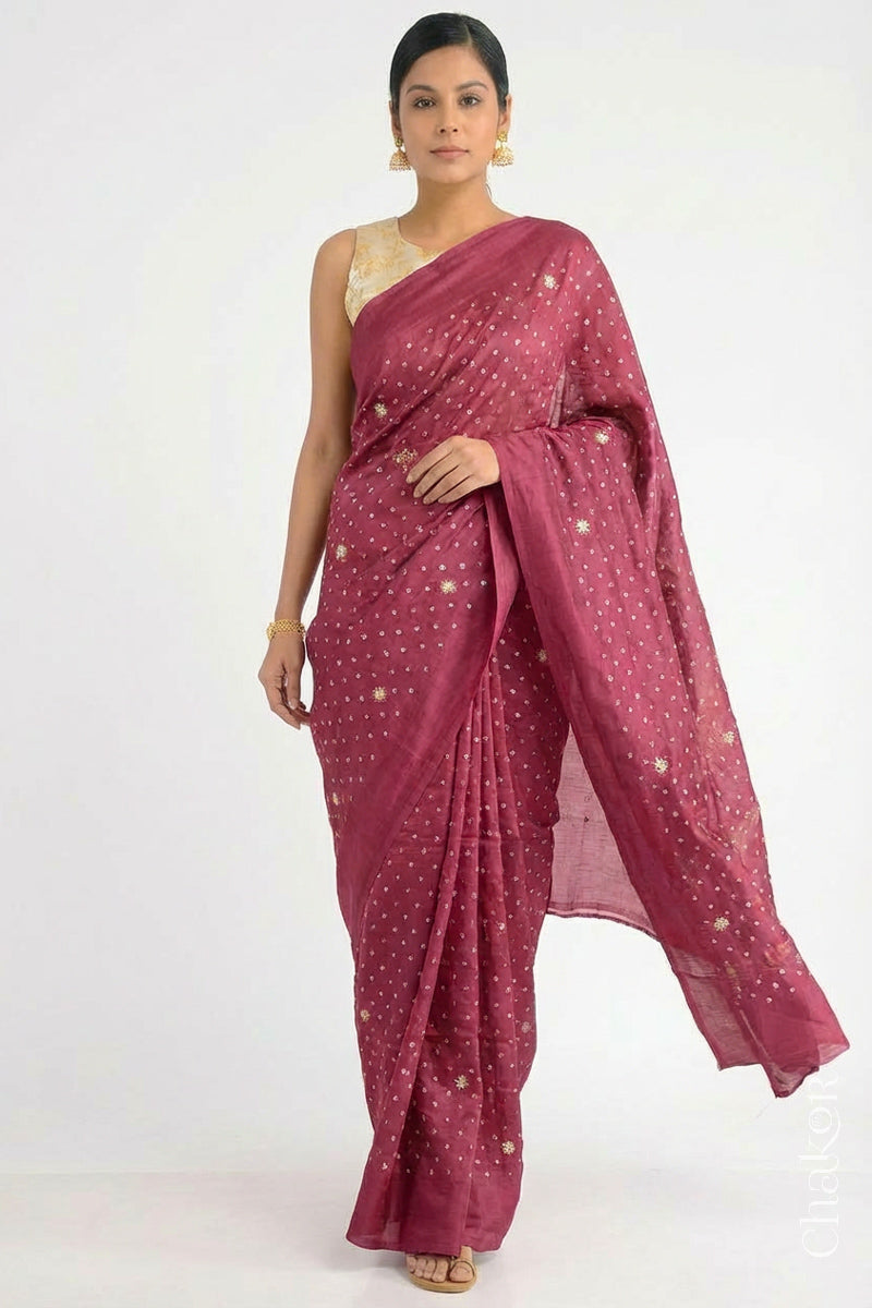 Woman wearing Dusty Red Bandhani Mulberry Pure Silk Saree, with handcrafted rai bandhej patterns using traditional tie-dye techniques from Kutch.
