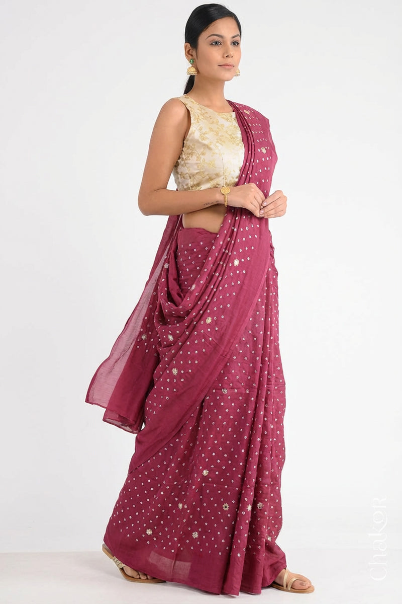 Woman wearing Dusty Red Bandhani Mulberry Pure Silk Saree, with handcrafted rai bandhej patterns using traditional tie-dye techniques from Kutch.