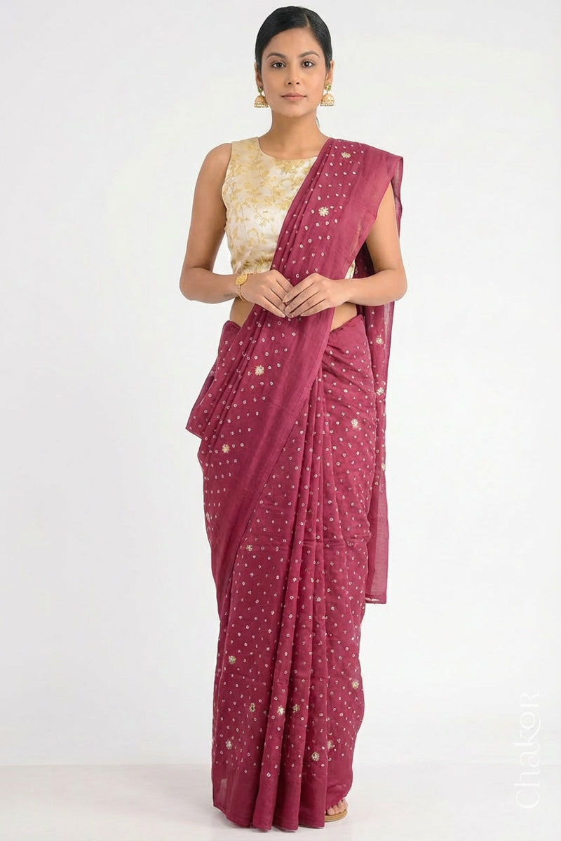 Woman wearing Dusty Red Bandhani Mulberry Pure Silk Saree, with handcrafted rai bandhej patterns using traditional tie-dye techniques from Kutch.