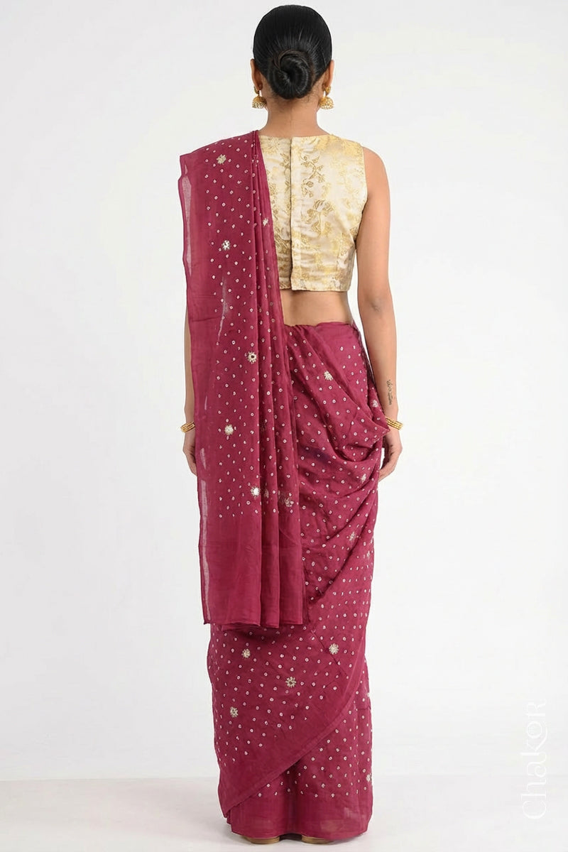 Woman wearing Dusty Red Bandhani Mulberry Pure Silk Saree, with handcrafted rai bandhej patterns using traditional tie-dye techniques from Kutch.