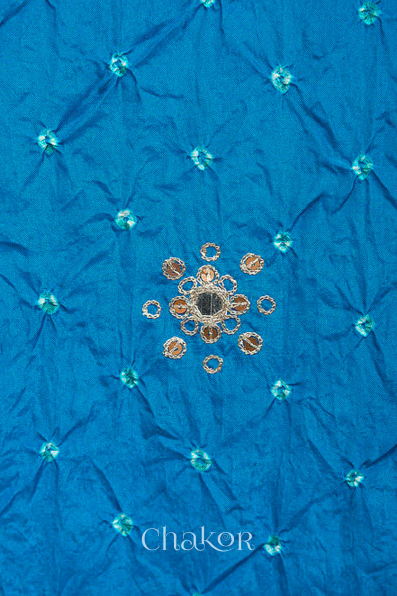 close-up of peacock blue Bandhani mulberry silk dupatta with tie-dye dot pattern & detailed with Mirror work, Sequin work, Zari work, Bead edging.