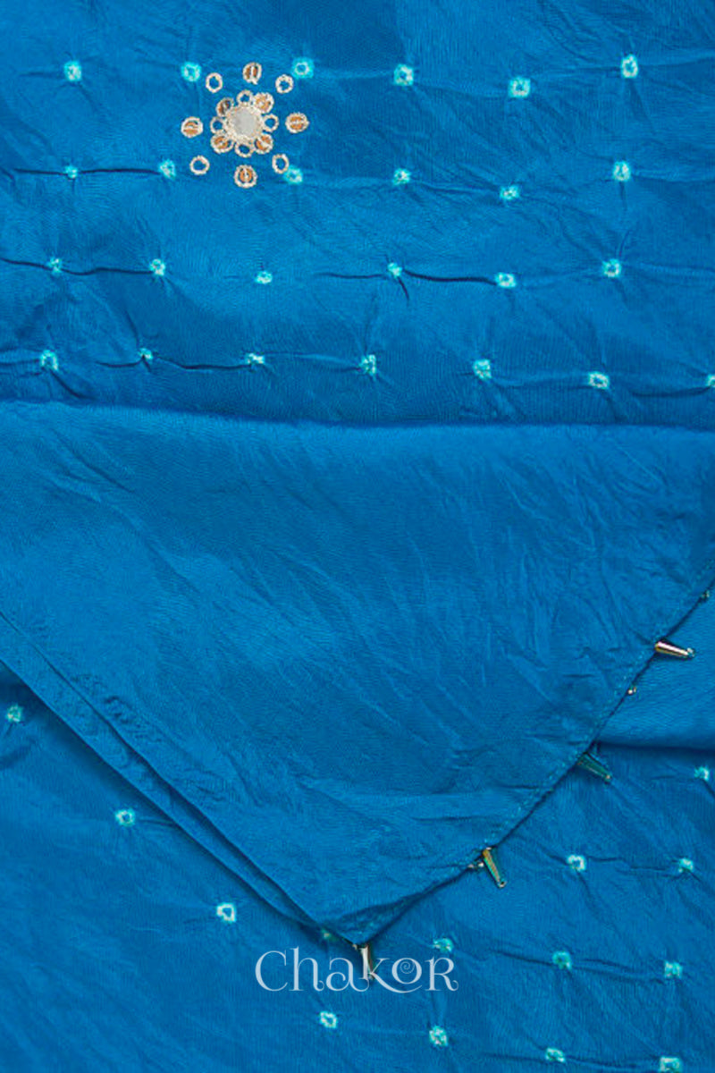 close-up of peacock blue Bandhani mulberry silk dupatta with tie-dye dot pattern & detailed with Mirror work, Sequin work, Zari work, Bead edging.