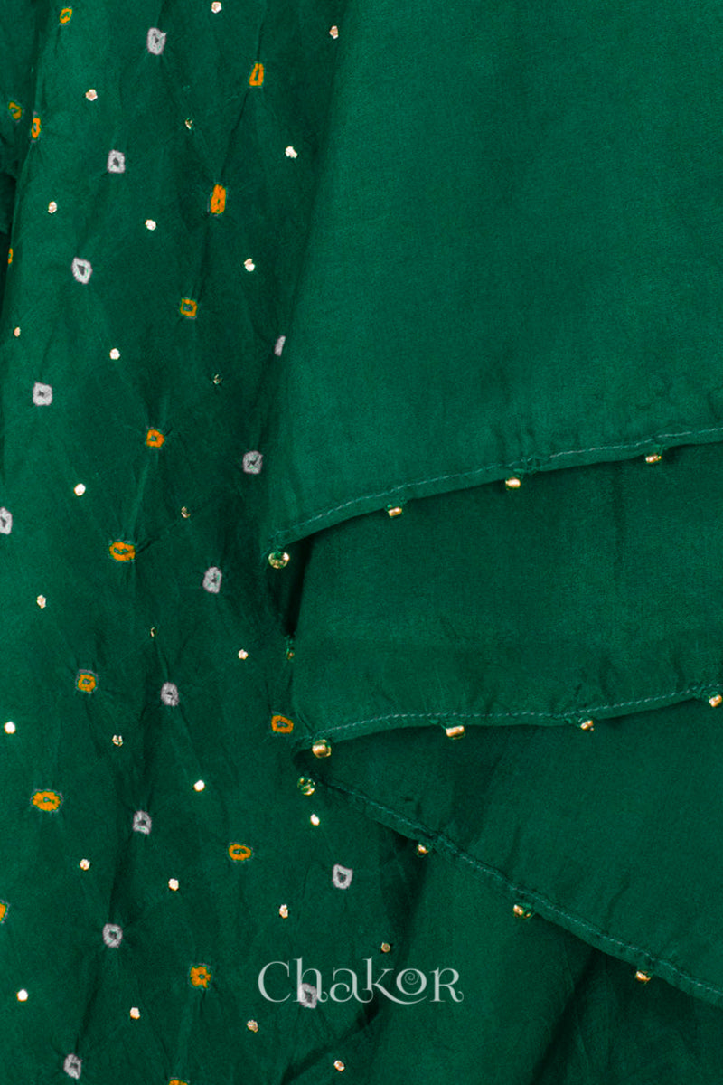 close-up of green Bandhani mulberry silk dupatta with tie-dye dot pattern & detailed with Mukaish work & Bead edging.