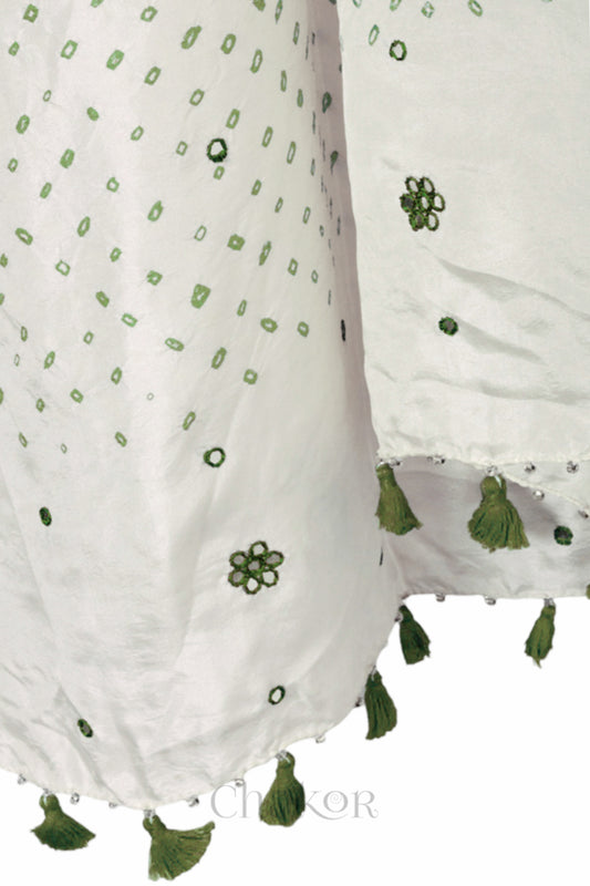 close up of off white Bandhani mulberry silk dupatta with tie-dye dot pattern & detailed with Mirror work & tassels.