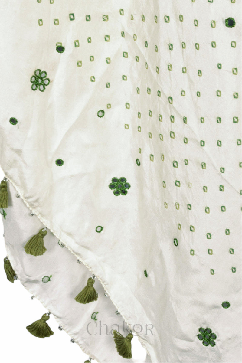 close up of off white Bandhani mulberry silk dupatta with tie-dye dot pattern & detailed with Mirror work & tassels.