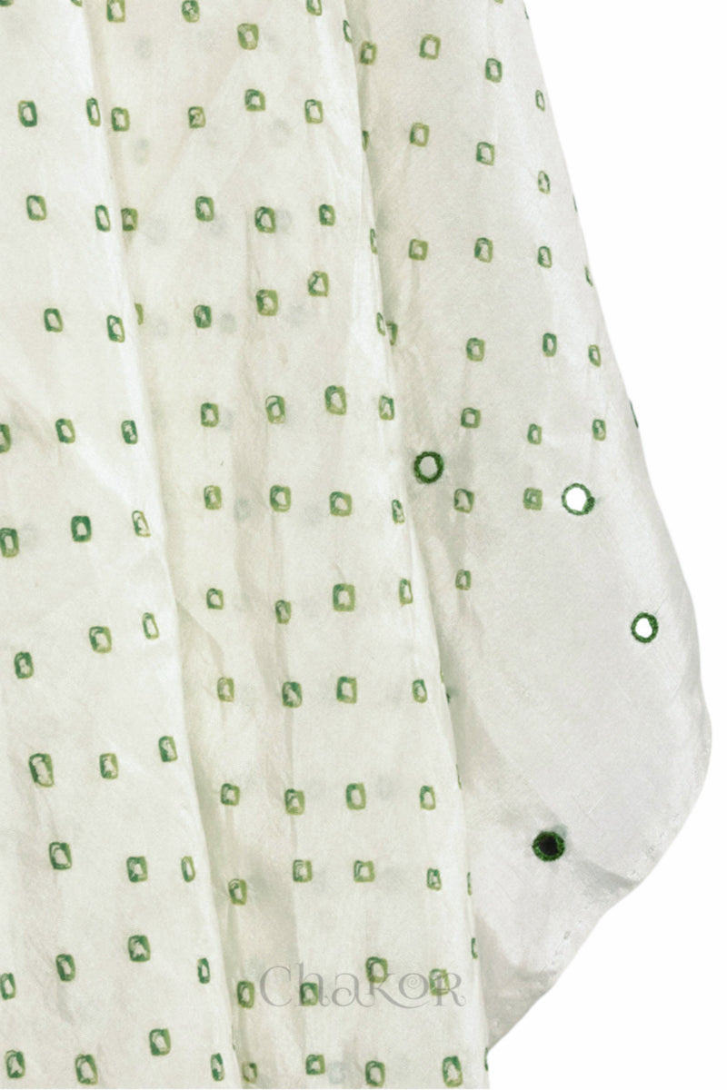 close up of off white Bandhani mulberry silk dupatta with tie-dye dot pattern & detailed with Mirror work & tassels.