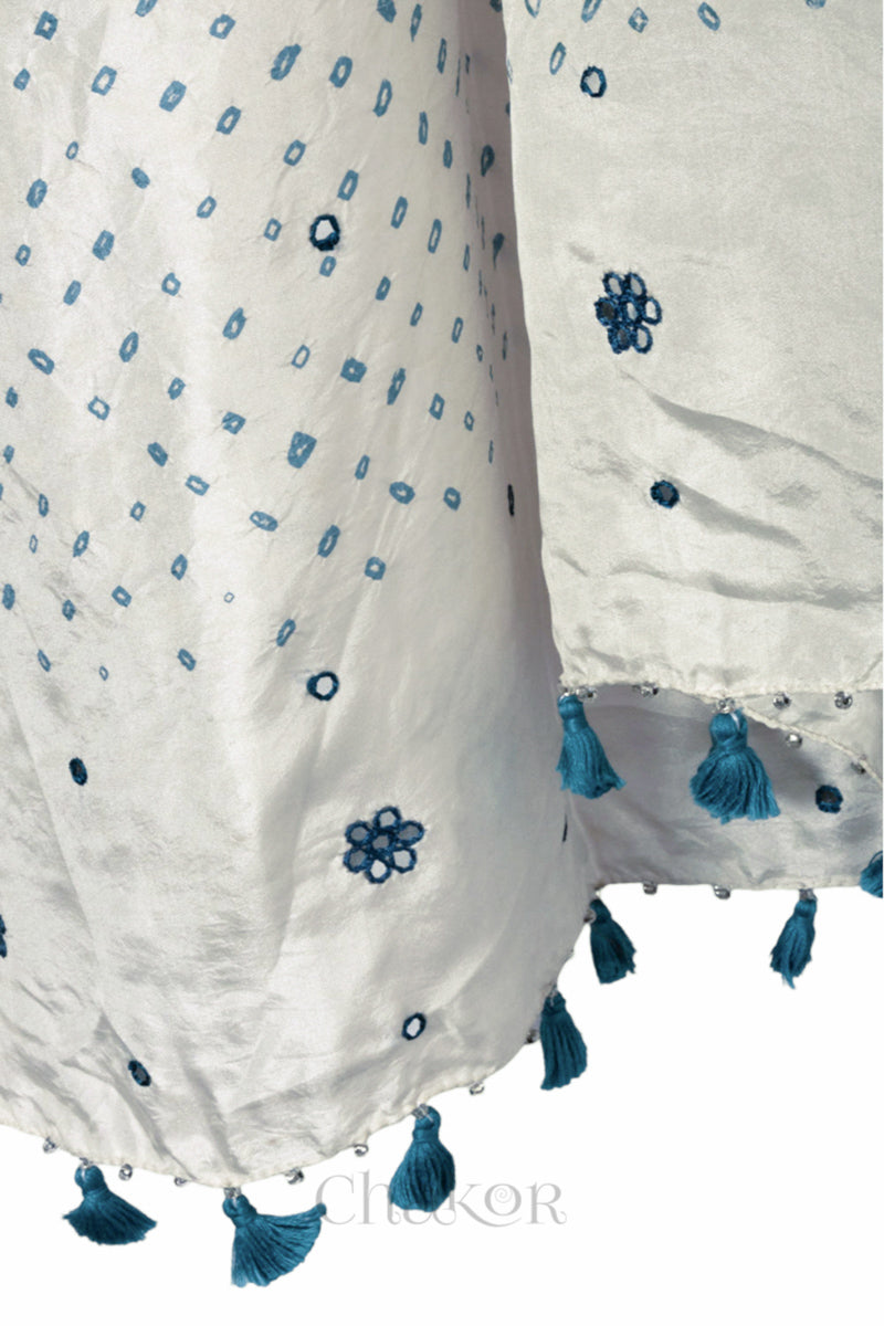 close up of off white Bandhani mulberry silk dupatta with tie-dye dot pattern & detailed with Mirror work & tassels.