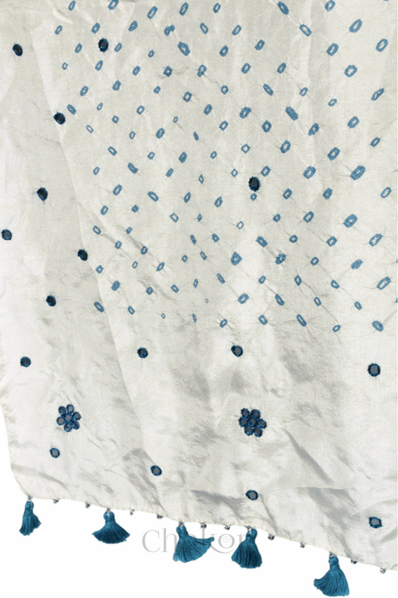 close up of off white Bandhani mulberry silk dupatta with tie-dye dot pattern & detailed with Mirror work & tassels.