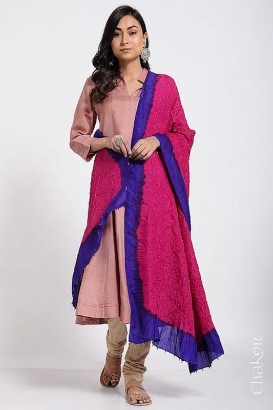 Woman wearing pink & purple border Bandhani mulberry silk dupatta with tie-dye dot pattern & detailed with Bead edging.