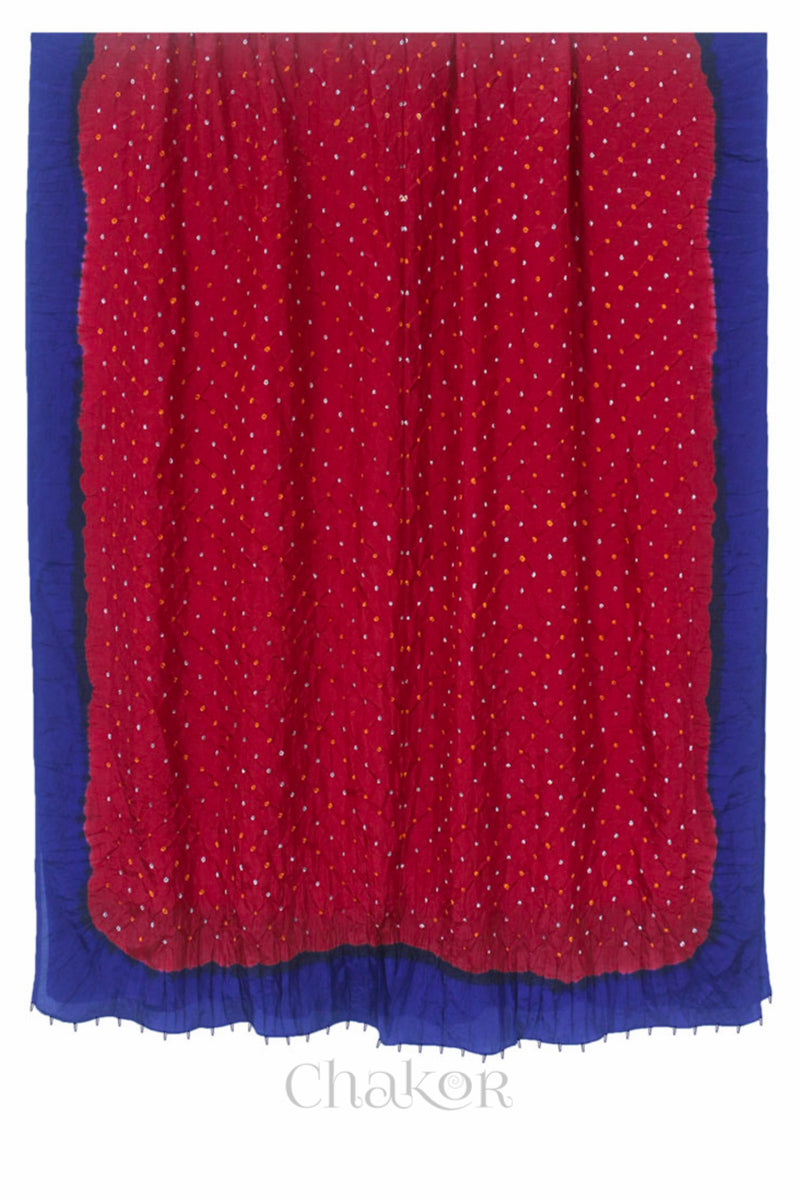 Full view of red & navy border Bandhani mulberry silk dupatta with tie-dye dot pattern & detailed with Bead edging.