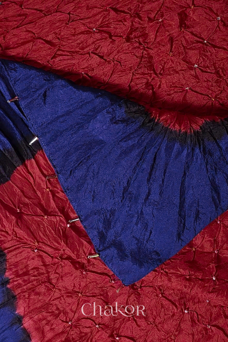 Close up of red & navy border Bandhani mulberry silk dupatta with tie-dye dot pattern & detailed with Bead edging.