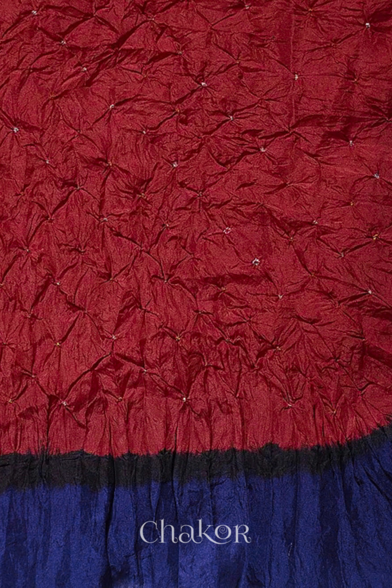 Close up of red & navy border Bandhani mulberry silk dupatta with tie-dye dot pattern & detailed with Bead edging.