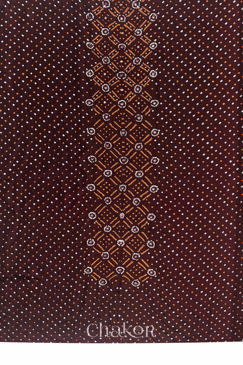 Full fabric panel of Maroon mulberry silk Bandhani (Rai Bandhej) with all-over white and yellow dots and a traditional border with zari embroidered pink mirror work & sequins embellishments – CHAKOR.
