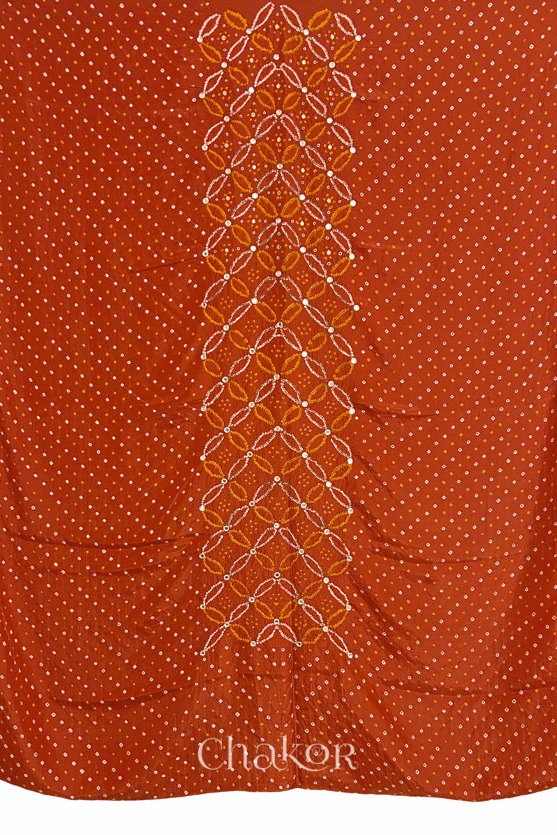 Full fabric panel of Rusty Orange mulberry silk Bandhani (Rai Bandhej) with all-over white dots and a floral border with golden zari mirror & sequins embroidery – CHAKOR.
