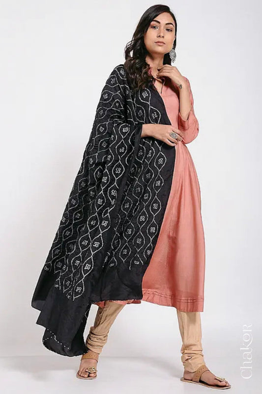Woman wearing black Bandhani mulberry silk dupatta with tie-dye dot pattern & detailed with Bead edging.