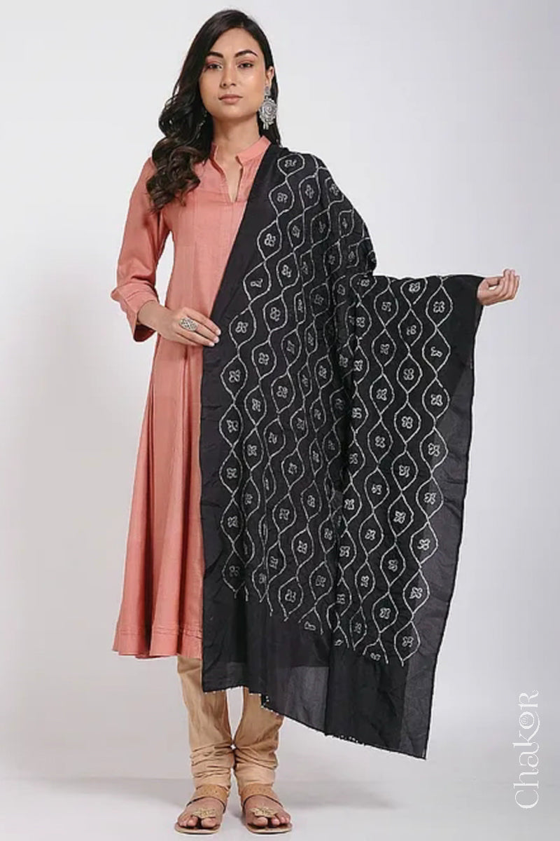 Woman wearing black Bandhani mulberry silk dupatta with tie-dye dot pattern & detailed with Bead edging.