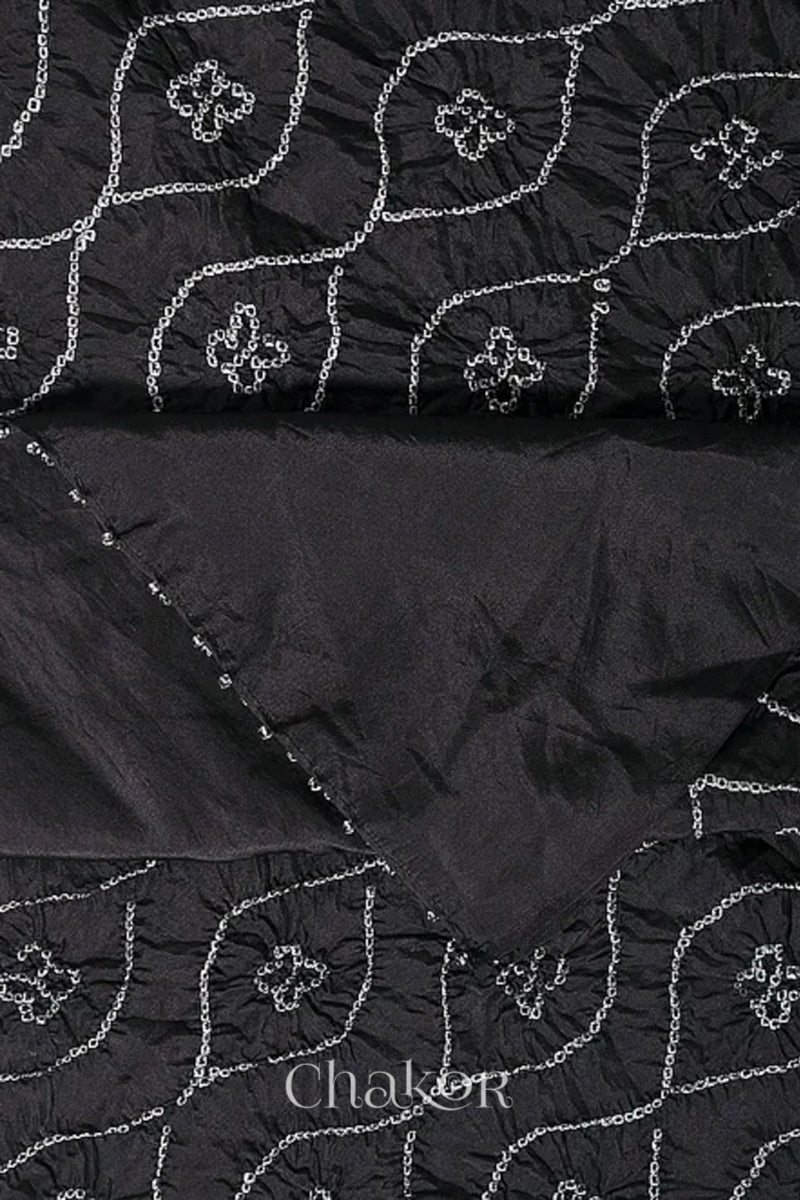 Close up of black Bandhani mulberry silk dupatta with tie-dye dot pattern & detailed with Bead edging.