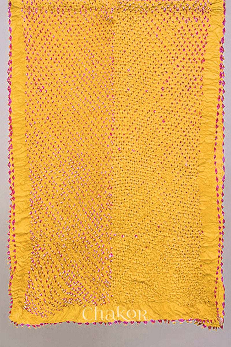 Full view of yellow Bandhani mulberry silk stole with pink tie-dye dot pattern.