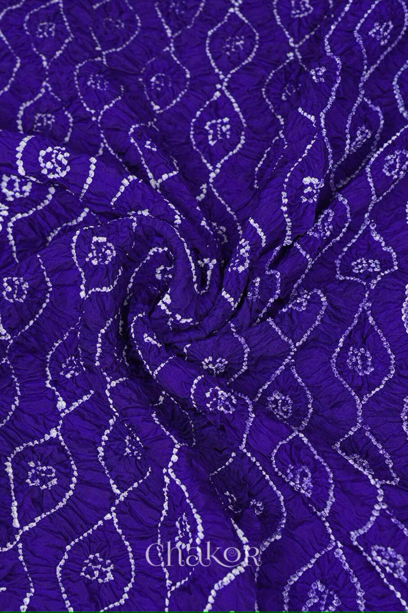 Close up of purple Bandhani mulberry silk dupatta with tie-dye dot pattern & detailed with golden lace.